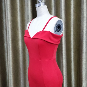 Detail of red off-shoulder V-neck strap evening dress showing the slim fit texture on a mannequin
