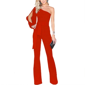 Detail of red one-shoulder jumpsuit with asymmetric long sleeve and waist tie belt