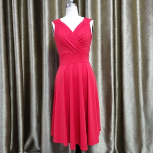 Detail of red V-neck sleeveless cocktail dress with elegant pleated bodice and A-line waist