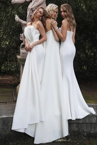 Elegant white satin evening gown with strapless pleated bodice in a lush garden setting