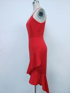 Side view of red V-neck dress with asymmetric ruffle hem on mannequin stand