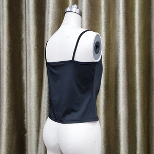 Detail view of black slim fit camisole with thin straps and stretchy fabric texture