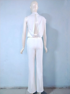 Detail view of white one-shoulder jumpsuit with hollow back design on a mannequin