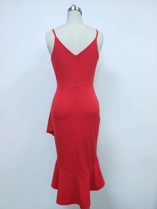 Detail of red bodycon dress featuring back V-neckline, hidden zipper and ruffled hemline