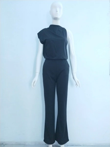 Detail of black one-shoulder jumpsuit featuring slim fit waist and wide leg trousers