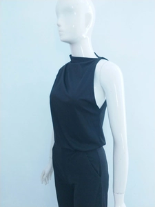 Detail view of black one-shoulder jumpsuit featuring a slim fit and side pocket design