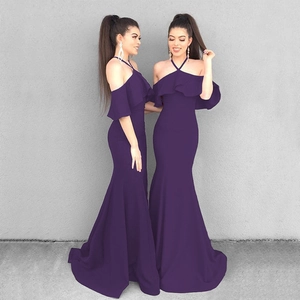 Detail of ruffle neckline and mermaid hem on a dark purple halter off-shoulder evening dress