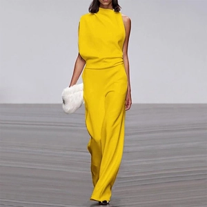 Detail of elegant yellow one-shoulder jumpsuit with draped pleats and wide leg trousers