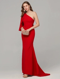 Detail of red one-shoulder evening dress with ruffled sleeves and mermaid tail silhouette
