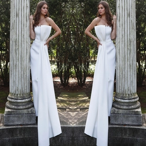 Detail of elegant white strapless jumpsuit with pleated bodice for formal banquets