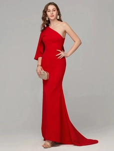 Detail view of red one-shoulder evening gown with ruffled strap and slim fit mermaid silhouette