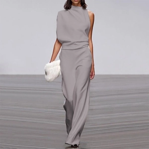 Detail of light grey one-shoulder jumpsuit with elegant draped neckline and wide legs