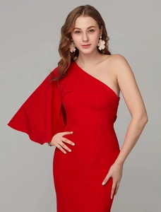 Detail of red one-shoulder evening gown with cape sleeve and slim fit design