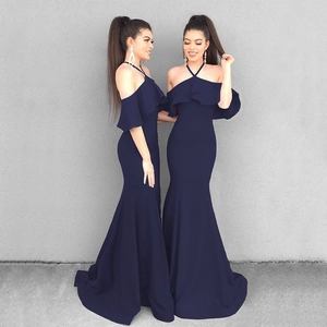 Detail of the ruffle neckline and off-shoulder design on a navy blue fishtail evening dress