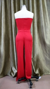 Detail view of the back zipper closure on this red off-shoulder wide-leg jumpsuit