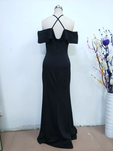 Detail of the back criss-cross thin straps and invisible zipper on black formal dress