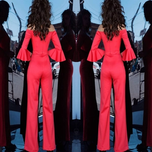 Detail of red off-shoulder jumpsuit featuring bell sleeves and wide-leg trousers back view