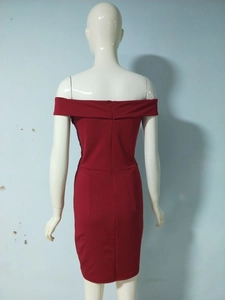 Detail view of the hidden zipper on back of a sleek off-shoulder red bodycon dress