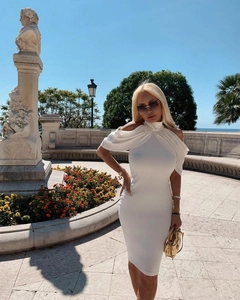 Outdoor shot of a slim-fit white halter neck midi dress with elegant cut-out shoulders