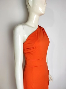 Detail of side invisible zipper on bright orange one-shoulder high waist dress