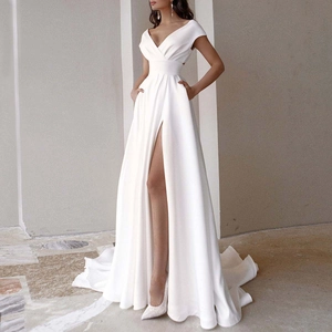 Close-up of elegant V-neck white satin gown featuring a high slit and sweeping floor-length train