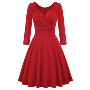 Detailed view of red cocktail dress featuring elegant V-neckline with cross pleat design