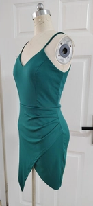 Detail of dark green V-neck dress showing side ruching and tulip-style hem design