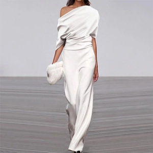 Detail of off-shoulder pleated white jumpsuit with wide-leg trousers and furry clutch bag