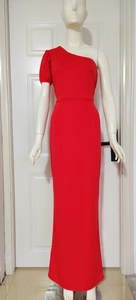 Detail view of red one-shoulder evening gown with ruffled puff sleeve and slim fit design