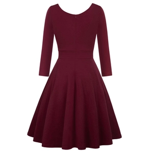 Detail of burgundy cocktail dress showing high waist, flared A-line skirt and zip back