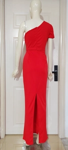 Detail view of red one-shoulder evening dress featuring a high back slit and lantern sleeve