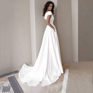 Elegant white satin floor-length dress with an open back and flowing train