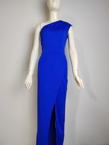 Detail of royal blue one-shoulder maxi dress with high slit and slim fit design