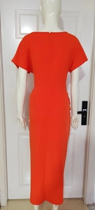 Detail view of the orange summer dress showing the back zipper and slim fit waist design