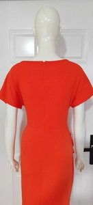 Detailed back view of orange V-neck dress featuring a sleek invisible zipper closure