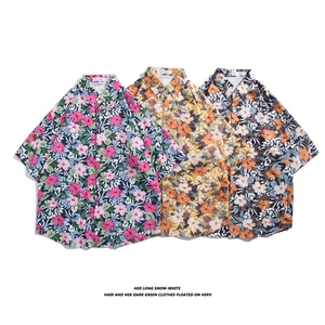Three men's Hawaiian floral shirts with tropical prints in pink, yellow, and black colors