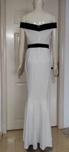 Detail of off-shoulder neckline and color-block fishtail design on a slim-fit evening dress