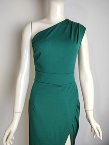 Detail of elegant dark green one-shoulder dress showing high waist and side slit design