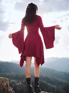 Detailed back view of burgundy dress with flared sleeves and asymmetric ruffled hem