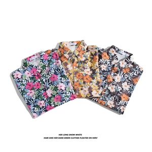 Three Hawaiian short sleeve shirts in navy, yellow, and black floral patterns for summer beach