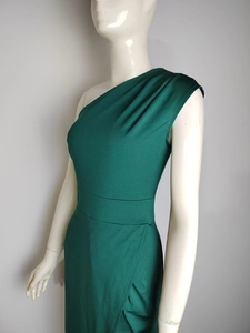 Detailed close-up of dark green one-shoulder dress with elegant pleated shoulder detail