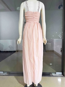 Detail of peach chiffon dress with silver sequin straps and elegant ruched bodice design