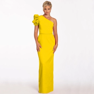 Detail of one-shoulder evening gown featuring a puff lantern sleeve in vibrant yellow