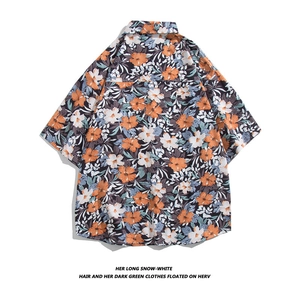 Flat lay of Hawaiian shirt featuring tropical floral print and classic lapel collar detail