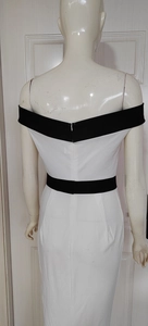 Detail view of the back zipper and black trim on white off-shoulder bodycon dress