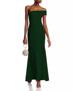 Deep green one-shoulder evening gown with high side slit and pearl handbag details