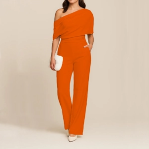 Detail of orange one-shoulder jumpsuit with high waist and wide-leg trousers design