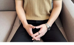 Close-up of men's knit polo shirt featuring a textured wavy knit pattern in beige