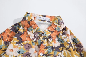 Detail of yellow Hawaiian shirt collar featuring hibiscus print and stitched size label