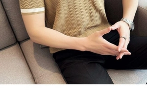 Detailed view of wave knit texture and white striped cuffs on khaki men Polo shirt